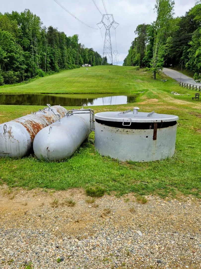 A couple of tanks sitting on top of grass.